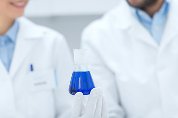 Image showing close up of scientists with test tube in lab