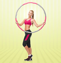 Image showing young sporty woman with hula hoop