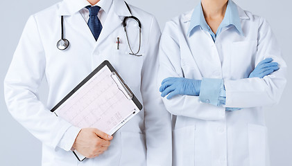 Image showing nurse and male doctor holding cardiogram