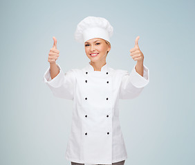 Image showing smiling female chef showing thumbs up