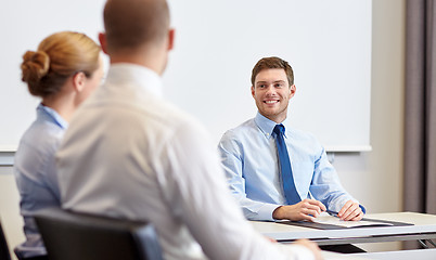 Image showing group of smiling businesspeople meeting in office