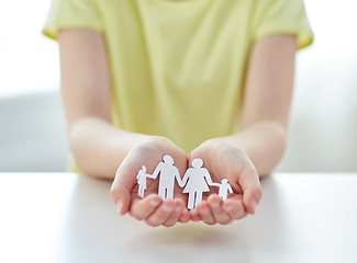 Image showing close up of girl hands with paper family cutout