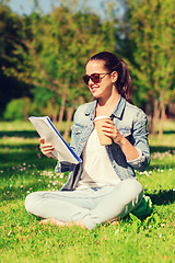 Image showing smiling young girl with notebook and coffee cup