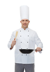 Image showing happy male chef holding frying pan and spatula