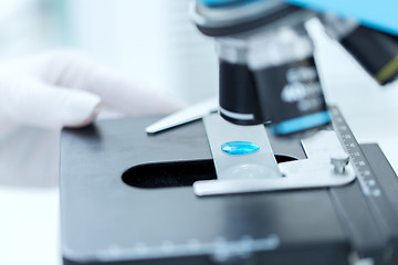 Image showing close up of scientist hand with test sample in lab