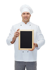 Image showing happy male chef cook holding blank menu board