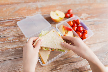 Image showing close up of woman with food in plastic container