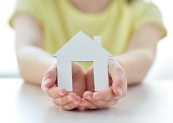 Image showing close up of happy girl hands holding paper house