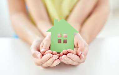 Image showing close up of woman and girl hands with paper house