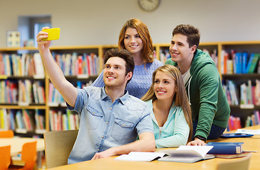 Image showing students with smartphone taking selfie at library