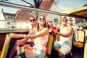 Image showing group of smiling friends traveling by tour bus