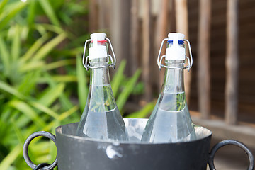 Image showing couple of water bottles in ice bucket at hotel