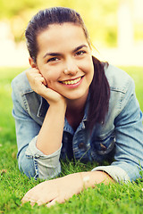 Image showing smiling young girl lying on grass