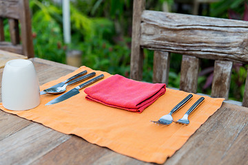 Image showing close up of cutlery with glass and napkin on table