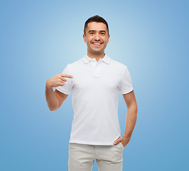Image showing smiling man in t-shirt pointing finger on himself