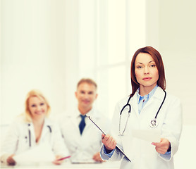 Image showing calm female doctor with clipboard