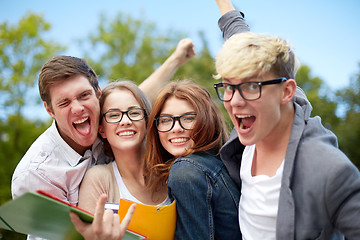 Image showing group of happy students showing triumph gesture