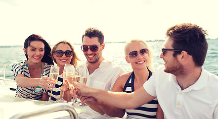 Image showing smiling friends with glasses of champagne on yacht