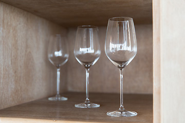 Image showing empty wine glasses set on shelf at restaurant