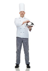 Image showing happy male chef cook holding cloche