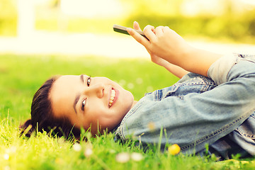 Image showing smiling young girl lying on grass