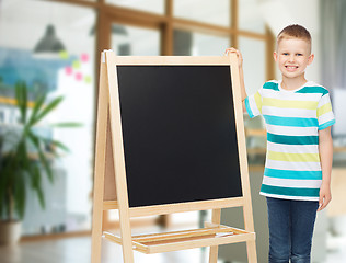 Image showing happy little boy with blank blackboard