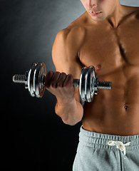 Image showing close up of young man with dumbbell