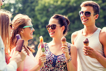 Image showing group of smiling friends with ice cream outdoors