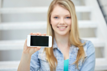 Image showing close up of happy teenage girl showing smartphone