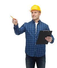 Image showing smiling man in helmet with clipboard