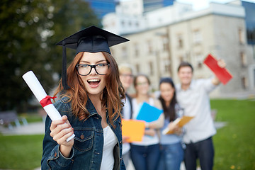 Image showing group of smiling students with diploma and folders