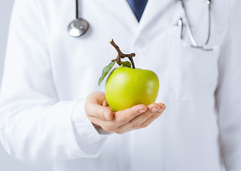 Image showing male doctor with green apple