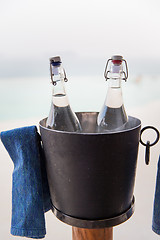 Image showing water bottles in ice bucket at hotel beach
