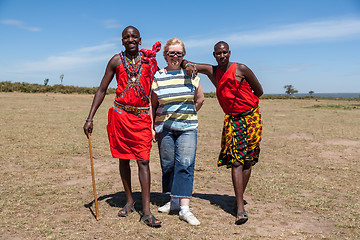 Image showing MASAI MARA,KENYA, AFRICA- FEB 12 Masai men in traditional clothes and European tourists, review of daily life of local people,near to Masai Mara National Park Reserve, Feb 12, 2010,Kenya