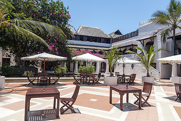 Image showing palm trees and tables