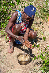 Image showing MASAI MARA,KENYA, AFRICA- FEB 12 Masai shaman is preparing a potion in traditional clothes, review of daily life of local people,near to Masai Mara National Park Reserve, Feb 12, 2010,Kenya