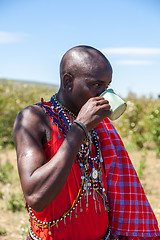 Image showing MASAI MARA,KENYA, AFRICA- FEB 12 Masai shaman is drinking a cup of cow blood in traditional clothes, review of daily life of local people,near to Masai Mara National Park Reserve, Feb 12, 2010,Kenya