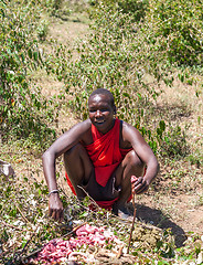 Image showing MASAI MARA,KENYA, AFRICA- FEB 12  Masai man is preparing a potion in traditional clothes, review of daily life of local people,near to Masai Mara National Park Reserve, Feb 12, 2010,Kenya