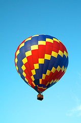 Image showing tricolored hot air balloon flying in sky