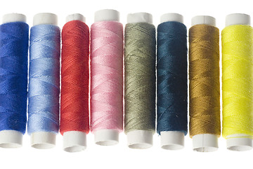 Image showing Row of colorful sewing threads

