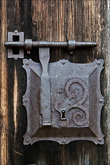 Image showing metal lock screw and wood