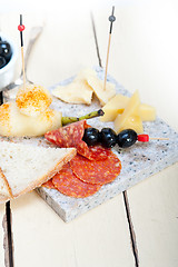 Image showing mix cold cut on a stone with fresh pears