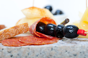 Image showing mix cold cut on a stone with fresh pears