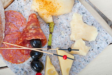 Image showing mix cold cut on a stone with fresh pears