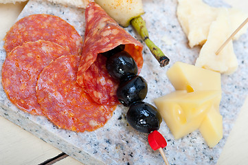 Image showing mix cold cut on a stone with fresh pears