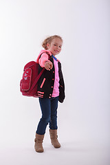 Image showing Girl with school bag points with the finger in the camera