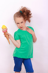 Image showing Young blond girl with ice-cream cone in the hand