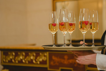 Image showing Waiter serving champagne on a tray