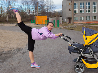 Image showing young woman is engaged in aerobics in a stadium