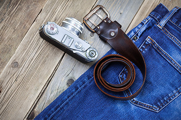 Image showing rangefinder camera, vintage leather belt and blue jeans
